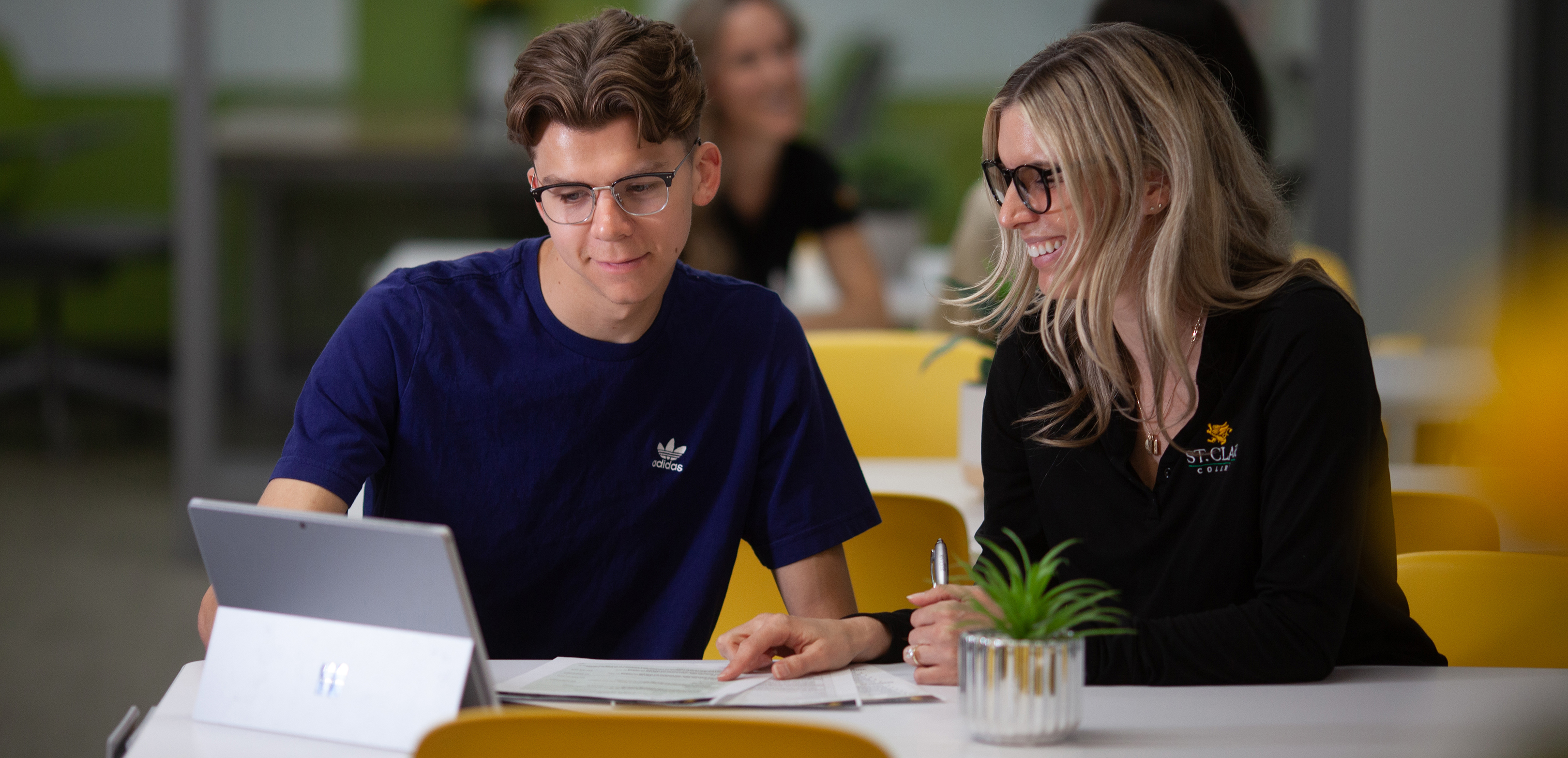 Student and Genesis staff member working on project